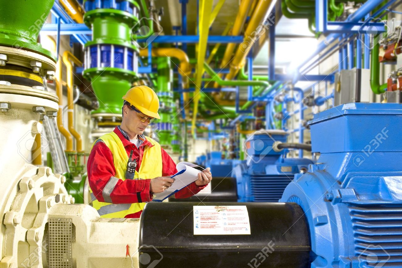 13903778-Engineer-looking-aty-a-checklist-during-maintenance-work-in-a-large-industrial-engine-room-Stock-Photo.jpg